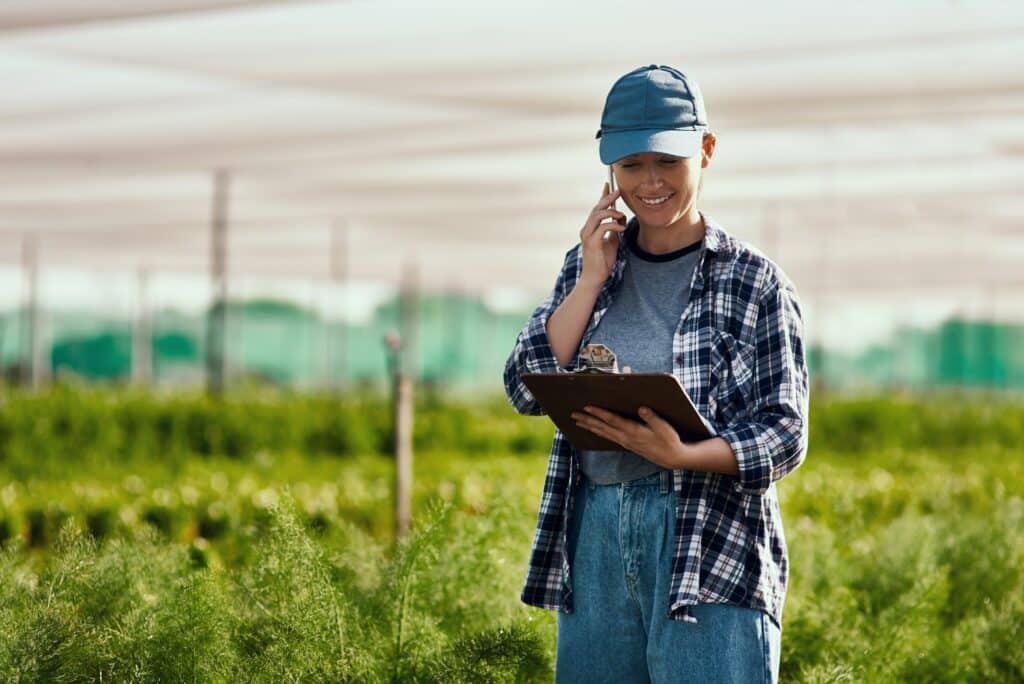 Cropped shot of an attractive young female farmer making a phonecall while working on her farm